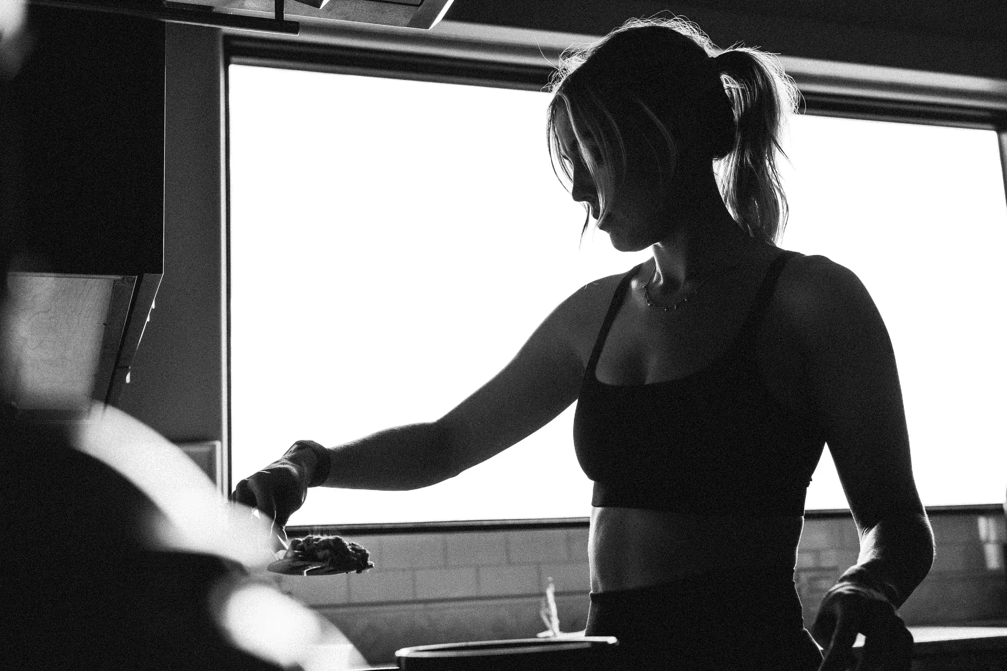 Black and white silhouette by a window